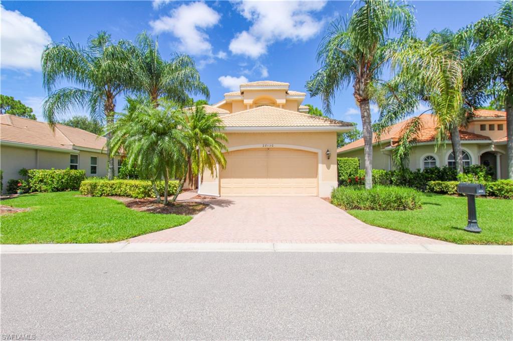 View of front of house featuring a garage and a front lawn