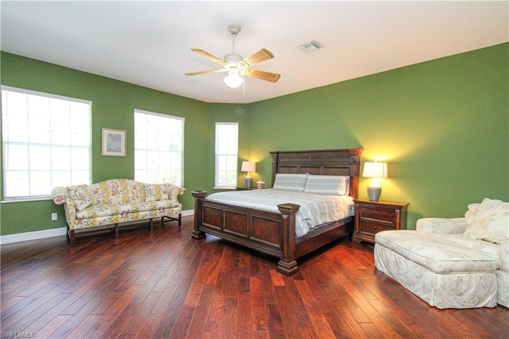 Bedroom featuring ceiling fan and hardwood / wood-style flooring