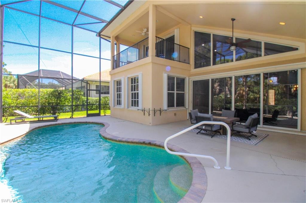 View of pool with a lanai and a patio area