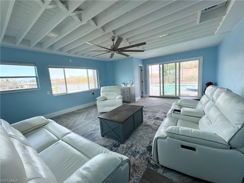 Living room featuring parquet floors and ceiling fan