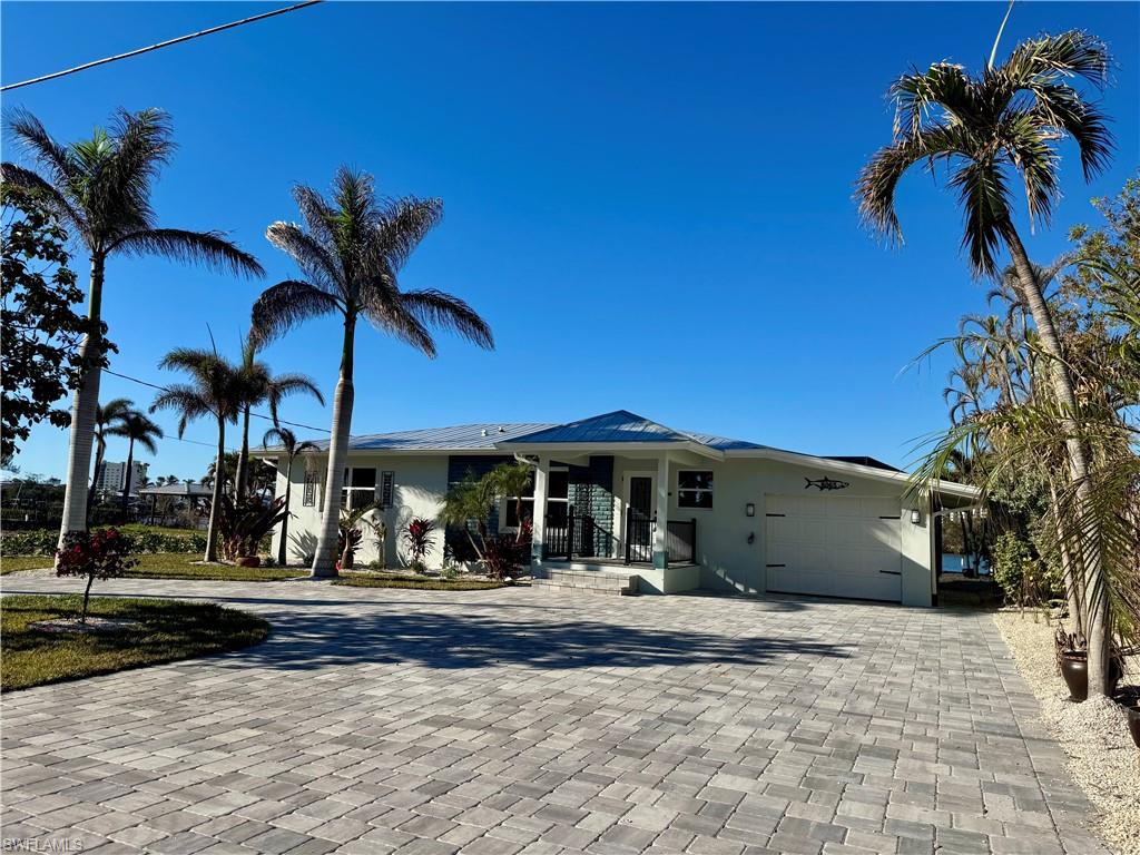 View of front of home featuring covered porch and a garage