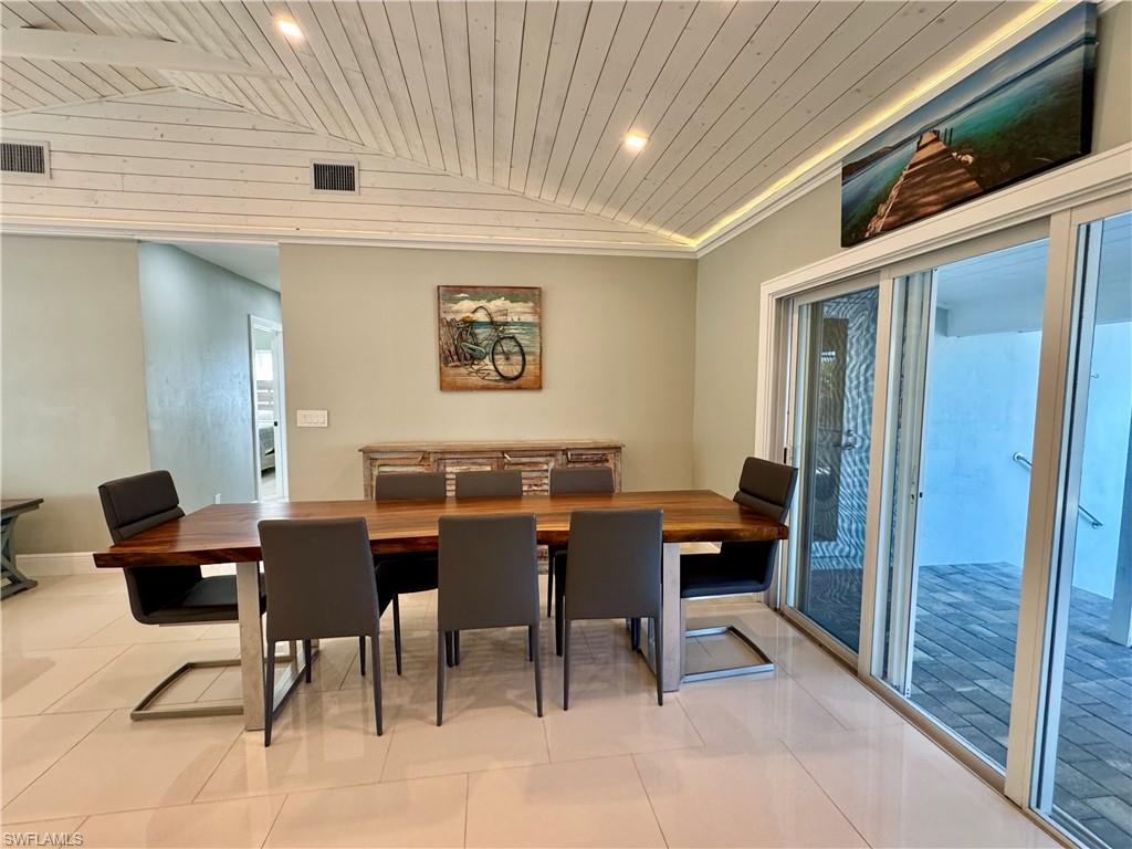 Dining space featuring plenty of natural light, lofted ceiling, and wood ceiling
