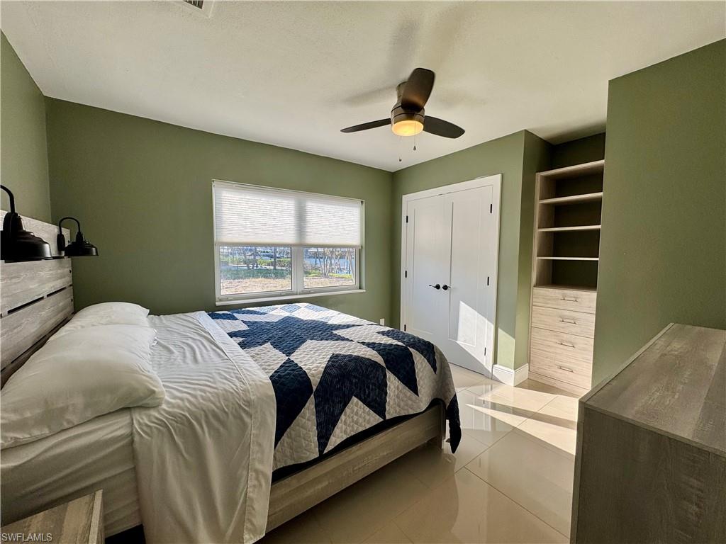 Tiled bedroom with ceiling fan