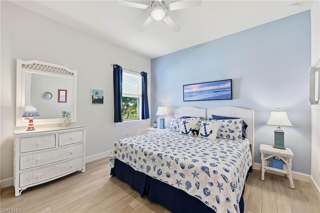 Guest bedroom  #2 featuring light tile flooring, complete with pocket door to make ensuite for guest privacy