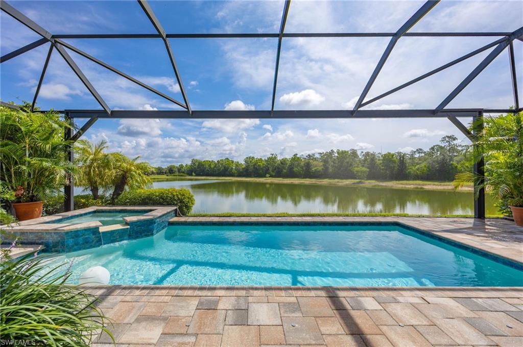 Screened outdoor pool with  integrated spa,  wide unobstructed water and preserve views for your enjoyment