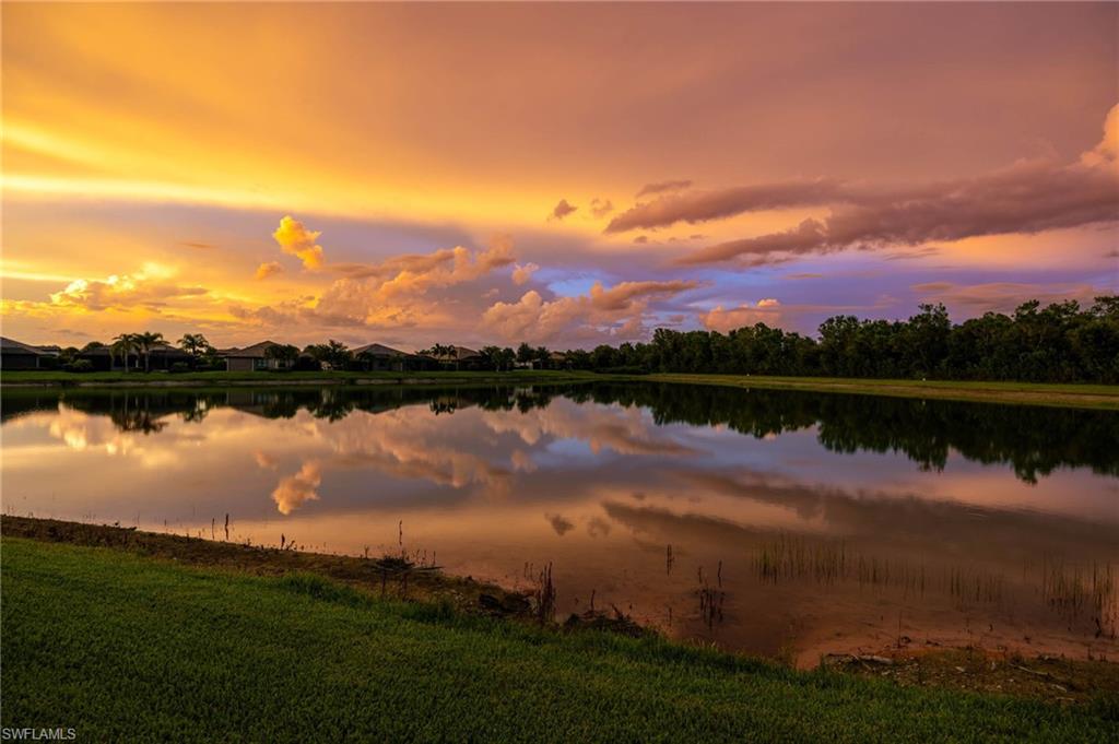 Waterfront property with expansive serene water reflections at sunset