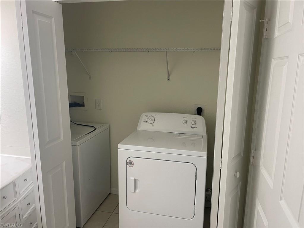 Laundry room featuring separate washer and dryer and light tile patterned floors