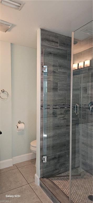 Full bath with light tile patterned flooring and a shower stall