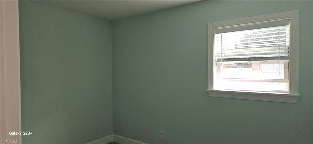 Unfurnished room featuring baseboards