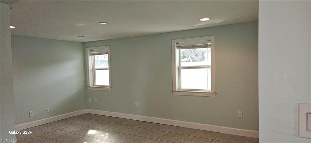 Unfurnished room with recessed lighting and light tile patterned flooring
