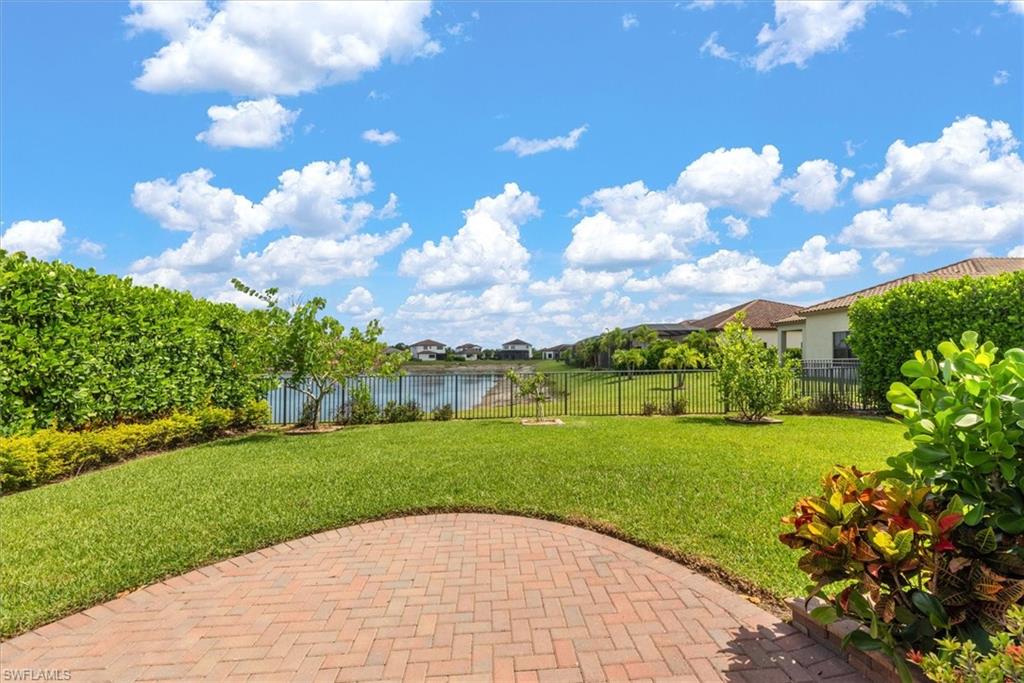 Rear view from patio. Includes HOA approved gate on a premium lot with lake view