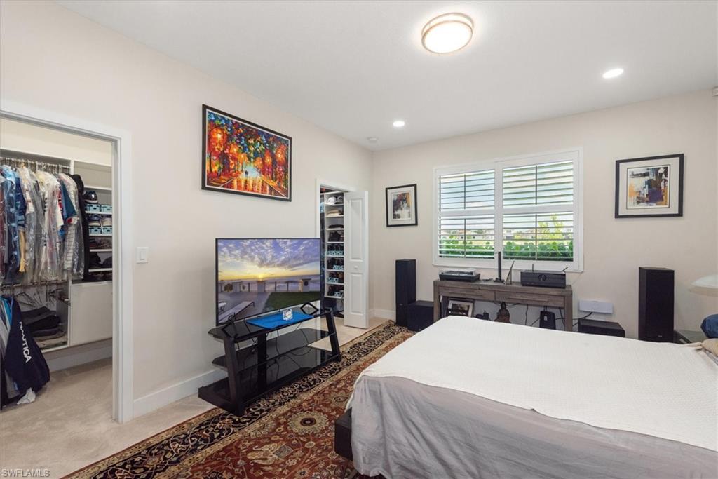 Neutral wall paint in a room with recessed lighting and a central flush-mount fixture. Includes two custom-built walk-in closets for his & hers