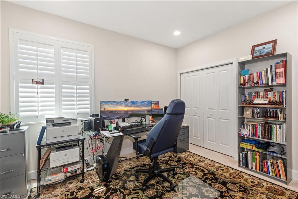 Room featuring light-colored walls, recessed ceiling lighting, used as an office.