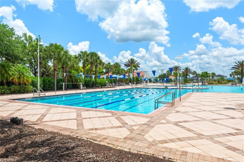 Expansive community pool area featuring a multi-lane lap pool and an additional large swimming pool