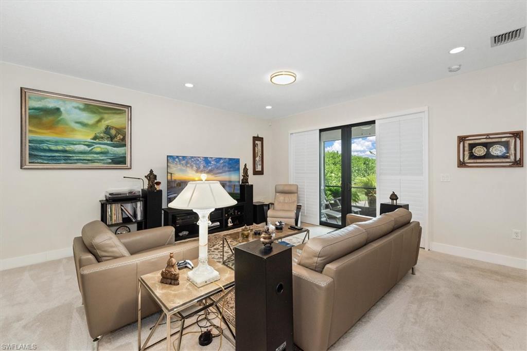 Living area featuring neutral-toned carpet flooring and light-colored walls