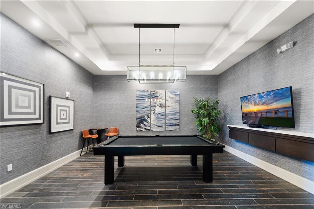 Recreational space featuring a billiards table, textured wall finishes, and wood-finish flooring