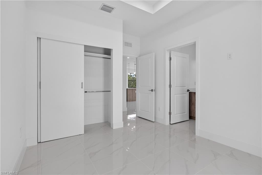 Bright interior featuring white walls and white baseboards