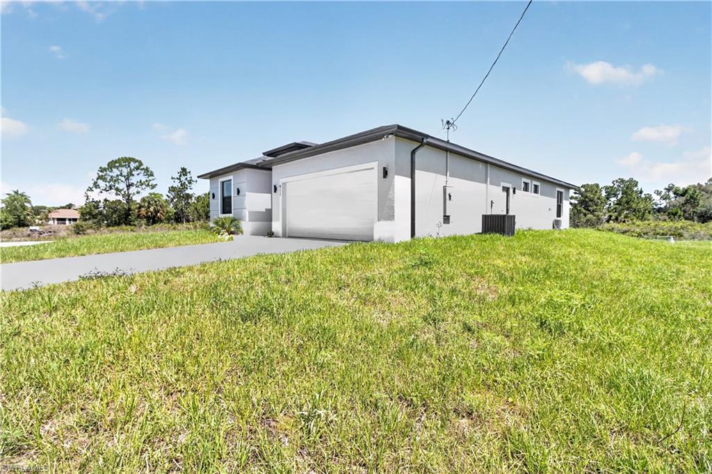 Contemporary-style property with a light gray stucco exterior and a dark gray roofline