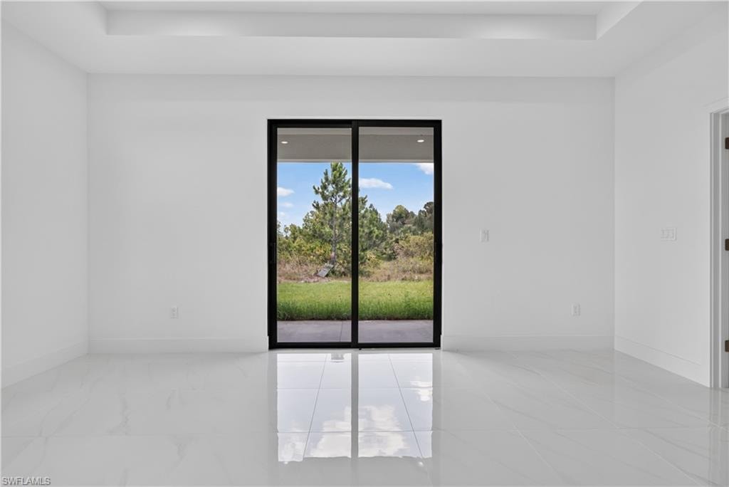 Bright interior space featuring a black-framed sliding glass door opening to a private outdoor area