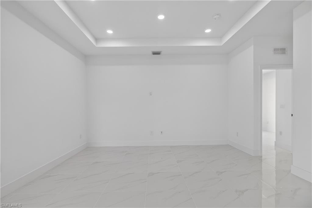 Recessed lighting illuminates a tray ceiling