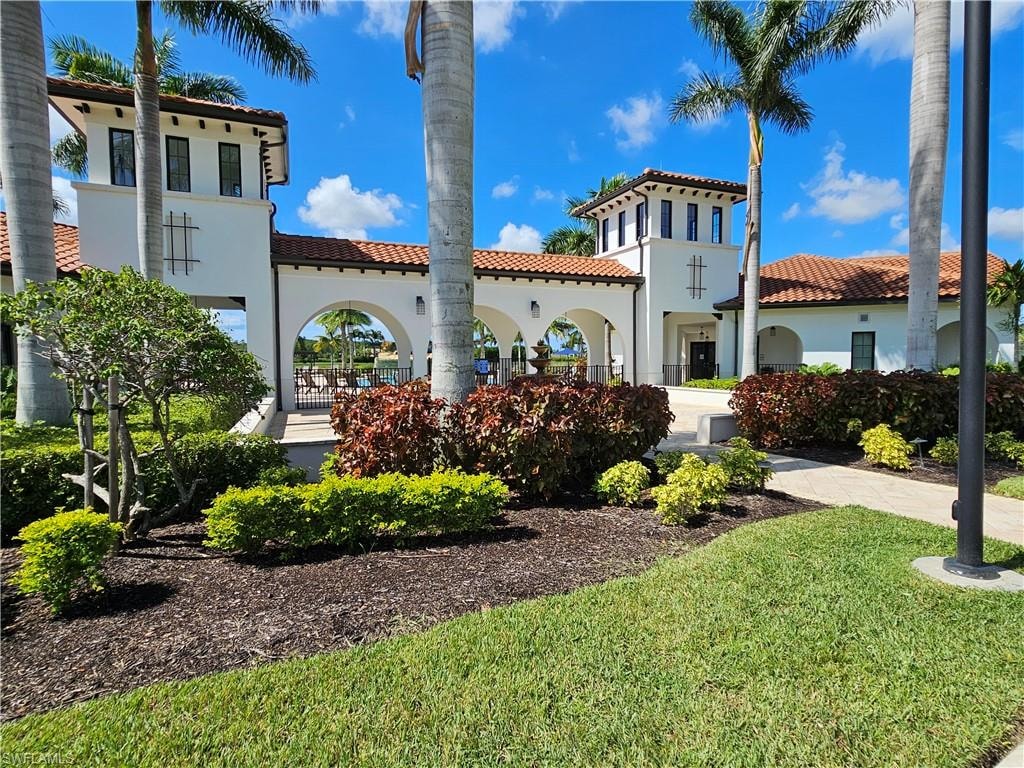 Mediterranean / spanish-style house with a front yard