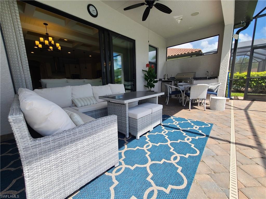 View of patio / terrace featuring ceiling fan, an outdoor hangout area, and glass enclosure