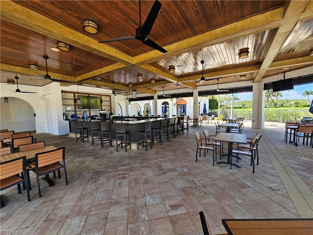 View of patio / terrace featuring ceiling fan and exterior bar