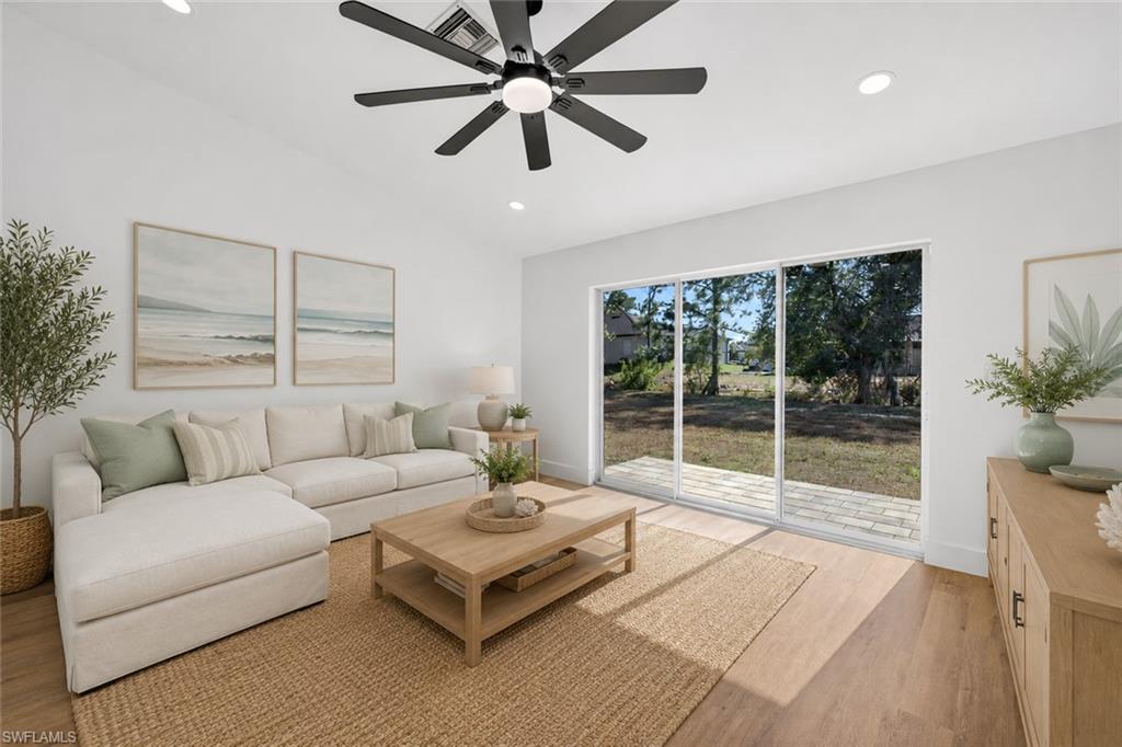 Living Room with Triple Sliders out to the Rear Brick Patio