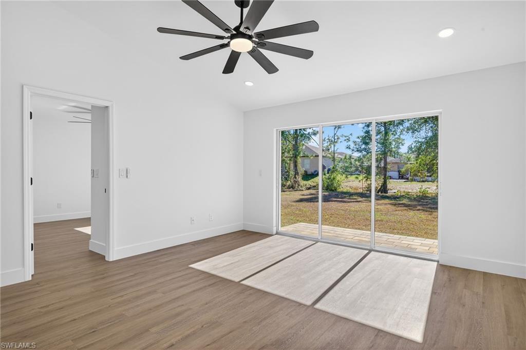 Living Room with Vaulted Ceilings & Large Modern Fan