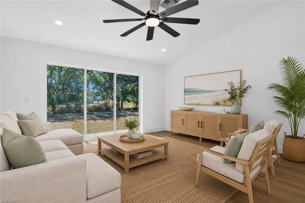 Living Room with Triple Sliders out to the Rear Brick Patio