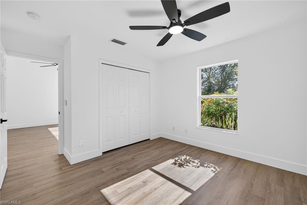 Primary Bed with Wide Plank Vinyl Floors