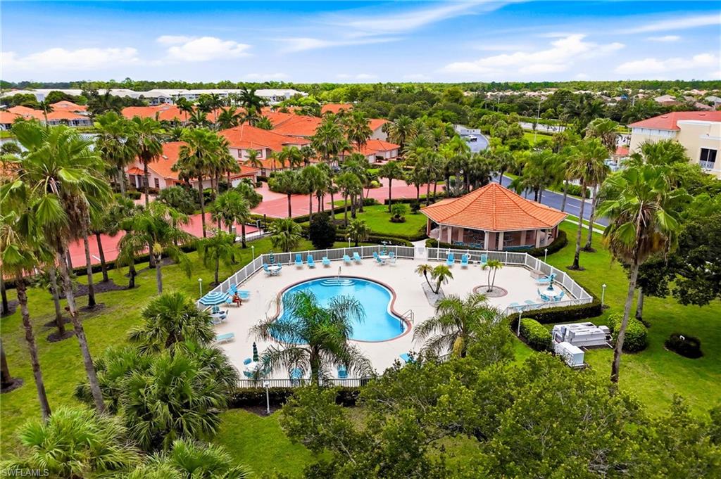 Elevated views showcase the sparkling community pool, clubhouse, and beautifully landscaped grounds.