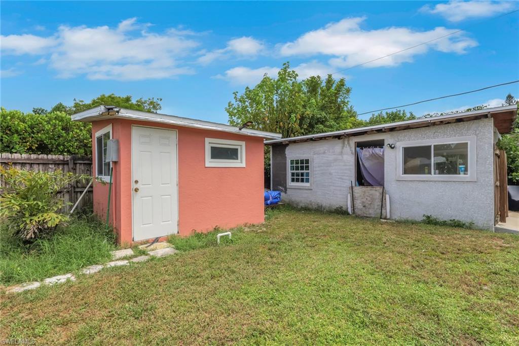 Additional structures in backyard. One with A/C and electricity and the other (grey) used as a storage.