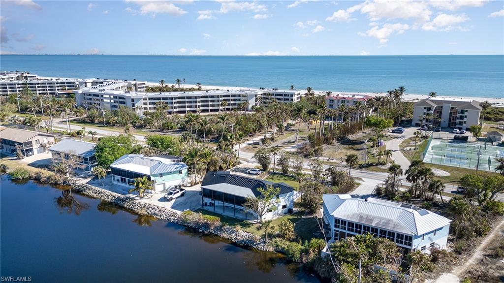 Waterfront property featuring a private boat dock, screened porch, metal roof, and direct water access