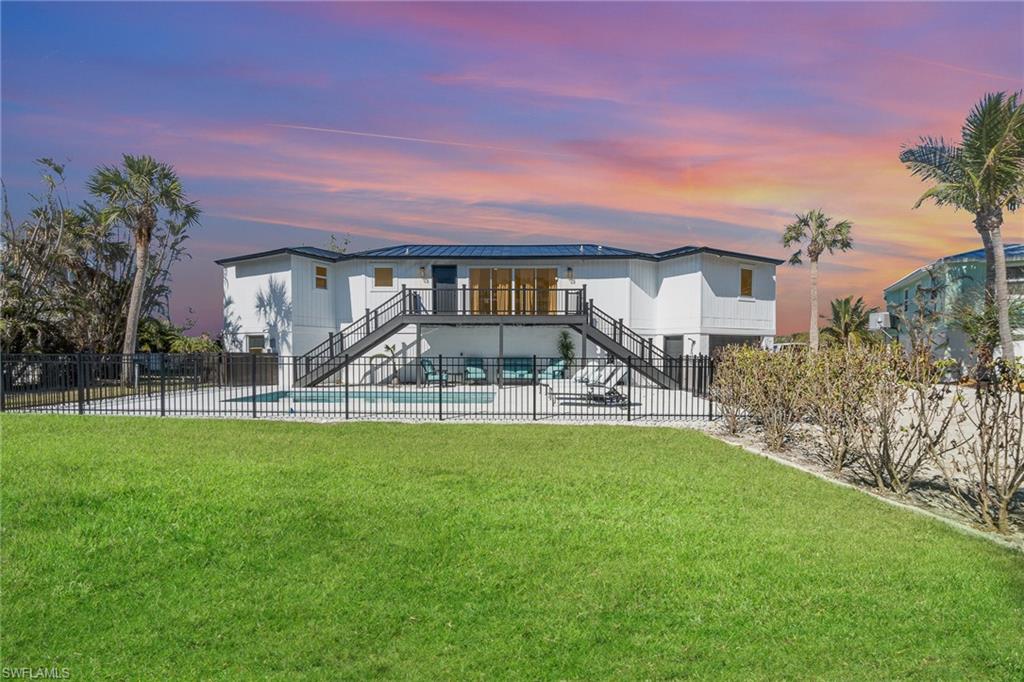 Contemporary two-story residence with a dark metal roof and white exterior