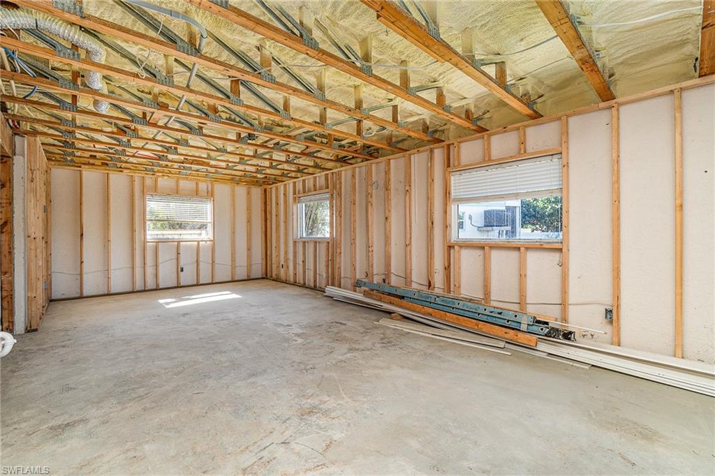 Open framing construction with exposed ceiling joists and wall studs