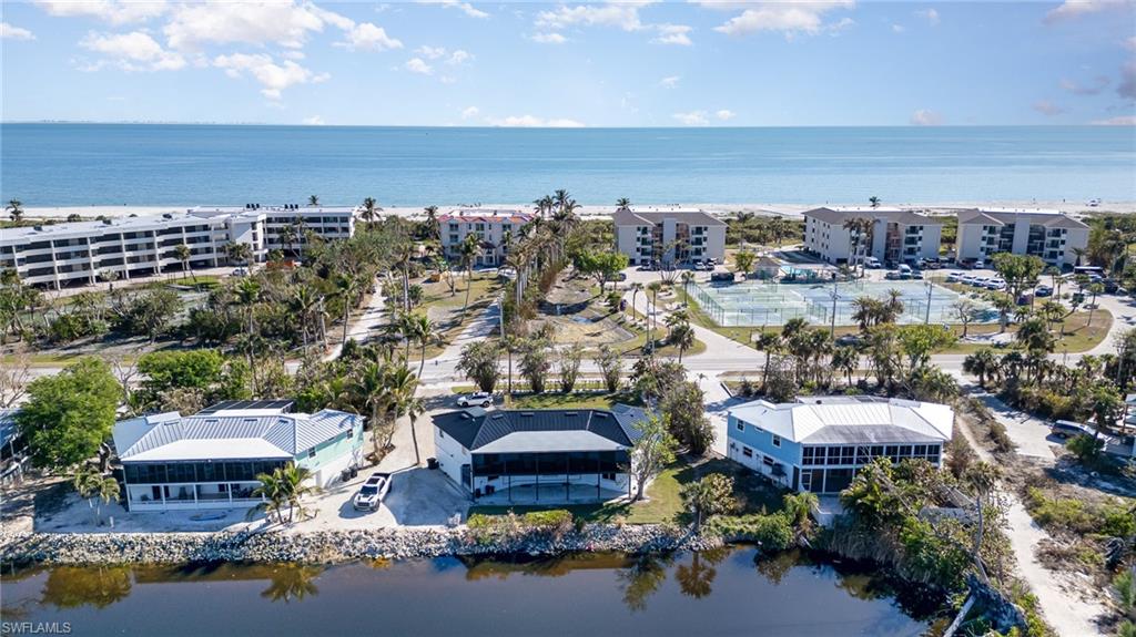 Waterfront property featuring a screened porch and metal roof