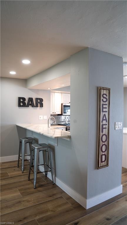 Kitchen pass-through with a stone countertop and an under-mount sink
