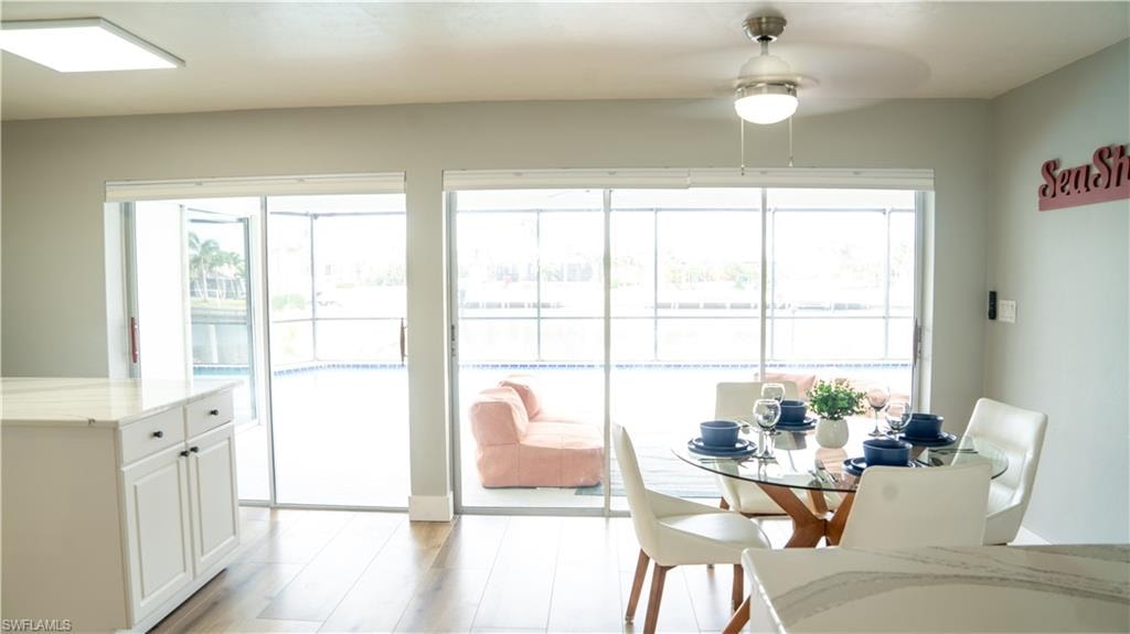 Spacious open-concept living area featuring wood-finish flooring and light gray walls