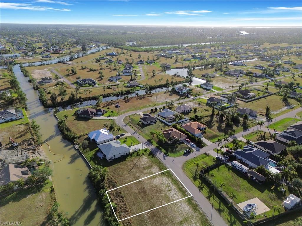 Birds eye view of property with a water view
