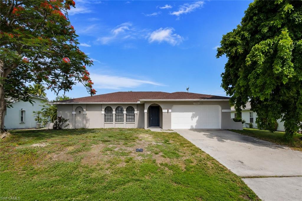 Single-story residence featuring a neutral-toned exterior, an attached two-car garage, and a concrete driveway