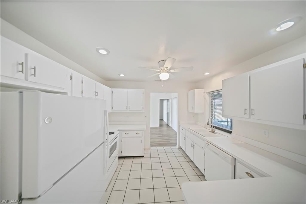 Kitchen featuring white tile flooring, white cabinetry with silver-tone hardware, recessed lighting, and a ceiling fan