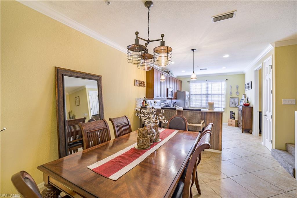 Dining area featuring a contemporary chandelier and crown molding