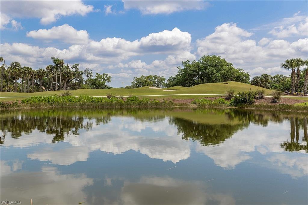 Mirror-still lake reflections and a manicured fairway capture the serene Verandah landscape.
