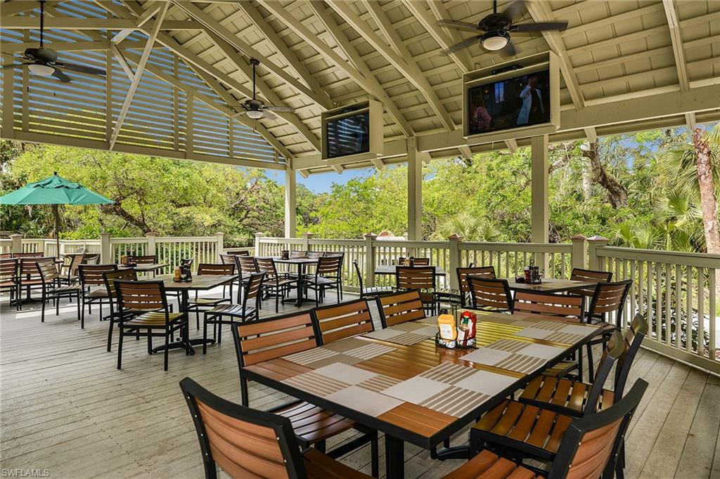 A covered, fan-cooled dining pavilion with treetop views for casual club gatherings.