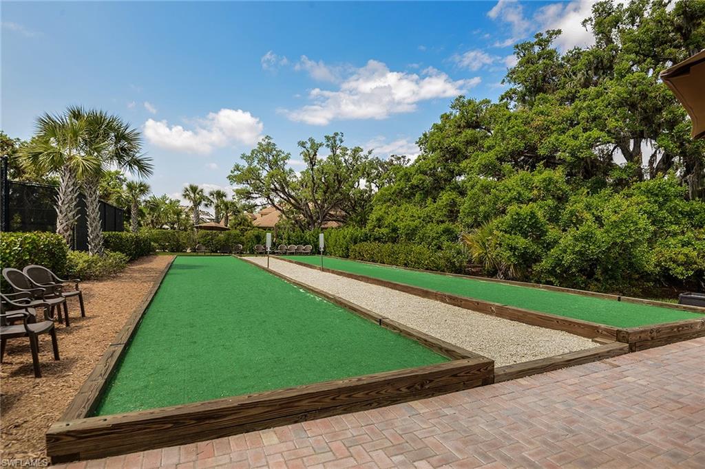 Manicured bocce courts with shaded spectator seating for friendly community play.