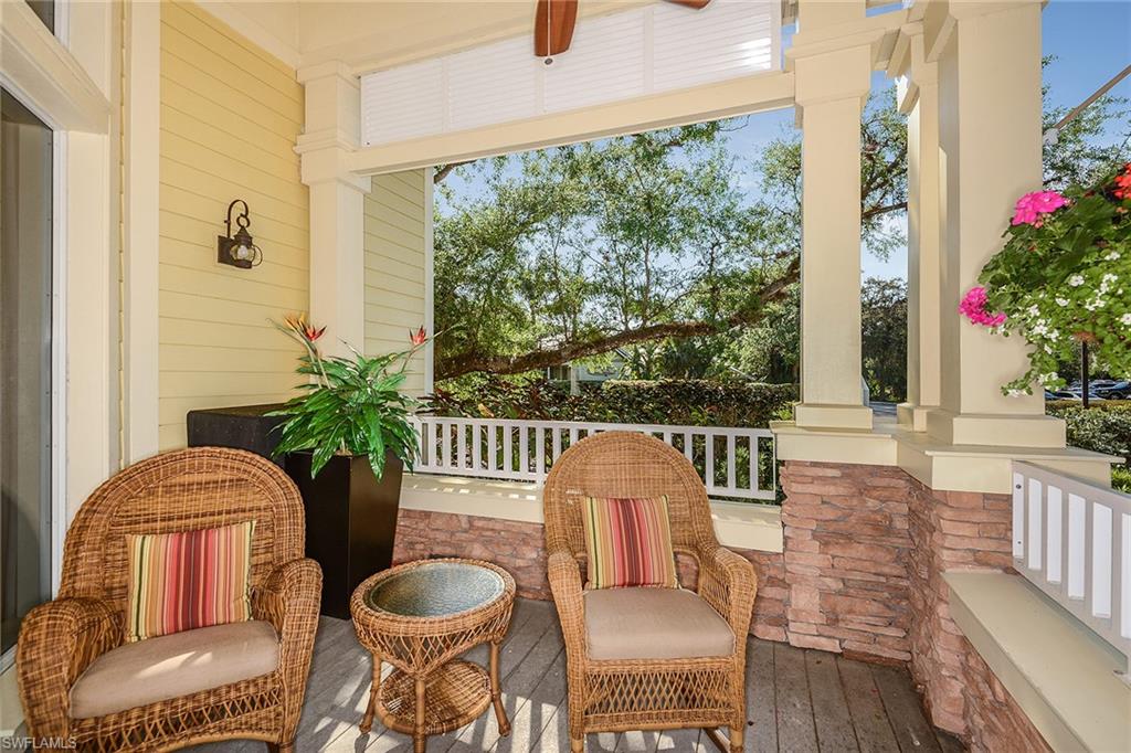 A breezy covered veranda with wicker seating and hanging florals for relaxed Florida afternoons.