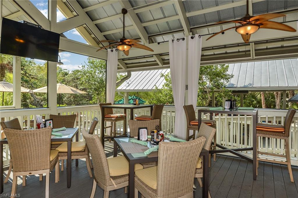 Vaulted, screened outdoor dining with breezy treetop views at the clubhouse.