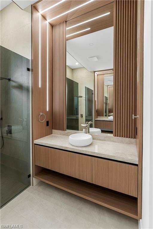 Modern bathroom vanity featuring wood-finish cabinetry, a white vessel sink, and a light-toned countertop