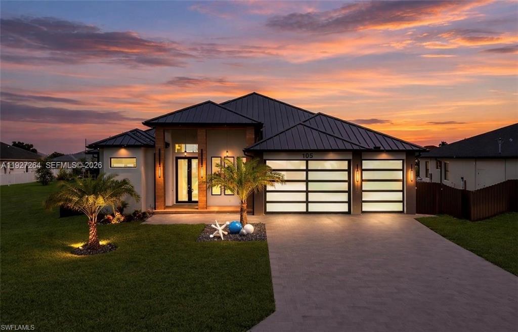 Contemporary facade featuring a dark metal roof and light-toned exterior